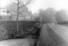 Greenhill Main Road, showing exit from footpath through break in wall