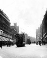 View: s16407 Tram No. 140 in High Street, John Walsh Ltd. and No. 40 Westminster Hotel, left