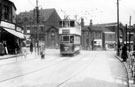 View: s16659 Tram No. 490 on Staniforth Road at the junction with Main Road, Darnall, No. 697, Hibbert's, confectioners and 699, Shentall's Ltd, grocer with the Wesley Methodist Church in the background
