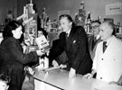 Opening of Brightside and Carbrook Co-operative Society, No. 29 Margetson Crescent, Mr J.R. Harper, President, selling oats to a customer, (last counter-service store to be opened in 1951)