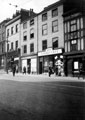 View: s16967 Haymarket, No. 17, Ormrod and Faulkner Ltd., tailors, No. 21, Mikado Cafe, Arthur Davy and Sons Ltd., Nos 23 and 25 Wiley and Co. Ltd., wine and spirit merchants