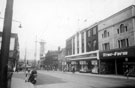 View: s16981 Haymarket looking towards Waingate showing construction of Castle Market, No. 10 True Form Boot Co., Nos. 12 - 14 F.W. Woolworth and Co. and Norfolk Market Hall, right