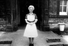 Miss Ivy Rotherham at the door of Round House on her retirement