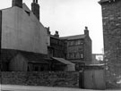 Hermitage Street showing yards belonging to houses fronting Bramall Lane (Nos. 26 - 30), right. Premises on St. Mary's Lane, in background