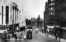 High Street, Nos. 51 - 55 Burton Montague Ltd., tailors and C and A Mode Ltd, left, Nos. 76 and 78, G. A. Dunn and Co., hatters, No 80-84, King's Head Hotel and Change Alley right