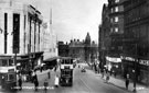 View: s17207 High Street, Nos. 51 - 55 Burton Montague Ltd., tailors and C and A Mode Ltd, left, Nos. 76 and 78, G. A. Dunn and Co., hatters, No 80-84, King's Head Hotel and Change Alley right