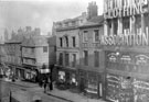 Market Place, High Street, (corner with Change Alley), No. 72 Capital and Labour Clothing Assoc., No 74, Geo. Thos. Wilkinson Newsholme, chemist, No. 76 W.F. Rodgers Ltd., printers, Nos. 78-80, John Wheeldon and Co., manufacturers of leather goods