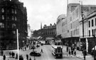 View: s17255 High Street including tram No. 264 and Nos. 59 - 65 C and A Modes Ltd. Pictured left is The Marples Hotel, No. 4 Fitzalan Square
