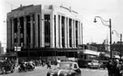 View: s17259 High Street and Market Place/Angel Street junction, Blitz damage (twelve years later) at Burton Montague Ltd., tailors, Nos. 51 - 55 High Street, also note the blank space where C and A Modes was prior to Blitz