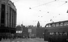 High Street looking towards Commercial Street, Blitz damage (twelve years later) at Burton Montague Ltd., tailors, Nos. 51 - 55 High Street, also note the temporary C and A Modes after the bombing of the original