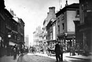 High Street at junction with George Street, shops on right include No. 34 (and No. 2 George Street), Charles Kino, tailor, No 36 and 38, H. Hawksley, hatter and Queen Victoria Hotel (entrance on George Street), No 31, Old Blue Bell, left (wher