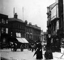 View: s17294 High Street, premises on right include No. 6 William Lewis, tobacconist, premises on left include Nos. 9 - 11 Sheffield Goldsmiths' Co., silversmiths, No. 13 Castle Chambers, No. 17 old Telegraph Offices