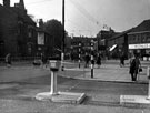 Streetscene on Main Road, Darnall at the junction with Greenland Road showing Nos. 215/221, Henry Wigfall and Son Ltd., Darnall Wesleyan Church (centre) and No. 222 Wellington Inn (left)