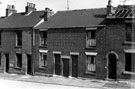 View: s17830 Unidentified Street showing Nos. 587 and 589 and derelict housing awaiting demolition, information with photograph reads Martin Street but does not have house numbers to correspond