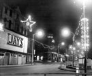 View: s18127 Christmas decorations on Moorhead looking towards Pinstone Street, No. 2 Moorhead, James Coombes and Co. Ltd., boot and shoe repairers and former premises of Jays Furnishing Stores, house furnishers