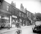 View: s18244 Nos. 9 Port Mahon Post Office, 11 Herbert Savage, butcher, 13 Hazlewood's, fruitier, 13a Watson's, butcher, 15 Hancocks', bakers, 15a Taylors', pork butcher, Netherthorpe Place looking towards the junction with Ellison Street