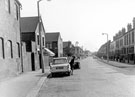Norborough Road looking towards St. Lawrence Road with Hatherley Road first left showing a member of Tinsley Library Staff getting out of her car