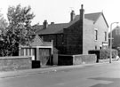 Garages and No. 39 Norborough Road near the junction with Lifford Street