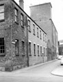 Nursery Lane looking towards Spitalfields from Johnson Street showing No. 9 Herbert Duke Ltd., paper warehouse (formerly Trinity Church Schools), Johnson Street (left) and rear of Crown Corn Mills, John Aizlewood Ltd., Nursery Street