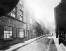 Orchard Lane looking towards Holly Street, junction with Sands Paviours and entrance to Court 2 (under road sign), right, railings belong to Central Schools