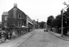General view of Park View Road with the junction of Burnell Road in the middle distance on the right, beyond the parked car.