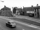 Derelict doctors surgery, No.1 (left), Hampshires Printers (formerly the New Inn), S. White, motor engineer, Wharncliffe Works (background), G.P. Wall Ltd., Magneto Works and Globe Works (centre), Penistone Road near the junction with Infirmary Road