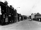 Nos. 97, 99 etc. (left), and No. 20 (detached house), Phillimore Road showing the railings of Phillimore County Primary School (right) looking towards Coleridge Road