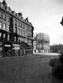 Pinstone Street, 1910 - 1930, premises include No. 6 William Timpson Ltd., shoe shop, No. 8 Fleming, Reid and Co. Ltd., hosiery store, No. 10 Haycock and Jarman Ltd., tailors, No. 12 Constance Favell, outfitters, Wilson Peck Ltd., in background