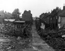 Derelict properties on Radford Place (centre) showing rear of Latimer Street (left) and partly demolished property on Bramwell Street (right)