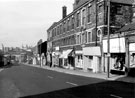 Shops on Spital Hill looking towards the Wicker Arches showing Nos. 105, Clive Barry, menswear, Nos. 101, C. G. Littlewood Ltd., motor coach proprietor, 97, 95 etc. and Nos. 91 Mottram and Longmate Ltd.