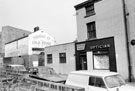 View: s19923 Thomas Street from The Moor. Premises include Neville Cohen, optician and Edward Wild and Son Ltd., butchers and cold storage