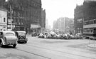 View: s20005 Fargate from Town Hall Square. No. 70 Fargate, premises on left include No. 68 Cantors, No. 66 Dean and Dawson Ltd., travel agents and Bank Chambers. Town Hall Square Rockery in foreground