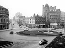 View: s20021 Town Hall Square and Goodwin Fountain, looking towards Fargate and Leopold Street, premises include Wilson Peck, No. 70 Fargate, H.L. Brown and Son Ltd., jewellers, No. 68 Cantors, No. 66 Dean and Dawson Ltd., travel agents
