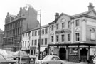 View: s20042 Nos. 1 - 13 Tudor Way from Tudor Street, premises include Wilks Bros. and Co. Ltd., ironmongers (on corner of Norfolk Street) and No 13, Adelphi Hotel, right, later the site of Crucible Theatre