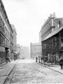 View: s20094 Tudor Street, from outside the Free Library, looking towards Sycamore Street and Arundel Street, premises on left include John Round and Son, silversmiths, Tudor Works and Theatre Royal. Premises on right include Lyceum Theatre