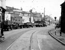 Looking towards the yard of James Cottam, haulage contractor, Upwell Street, Grimesthorpe with Colver's Yard behind the advertising hordings