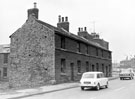 Awating demolition, Nos. 94 - 90 (left to right), Upwell Street with housing in Court No. 6 visible