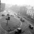 Traffic negotiating the roundabout, West Bar looking towards Paradise Street showing No. 85 P.J. Wilkinson, printer, Moseley's Arms public house and The Don Palace