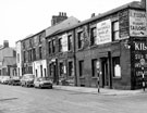 View: s20370 Wellington Street from Trafalgar Street showing No. 58 F. Jones, materials merchants, No. 60 C.A. and G. Forster and Sons Ltd., electro platers. These buildings were the former Trafalgar Works, right and back to back houses leading to Court 2