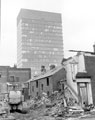 View: s20439 Demolition of houses, Western Bank. Rear of houses fronting Winter Street, right. University of Sheffield's, Arts Tower in background