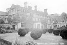 View: s20547 East front of Derwent Hall. Ornamental garden includes clipped Irish yews. Private St. Henry's Roman Catholic Chapel, right. Demolished 1940's for construction of Ladybower Reservoir
