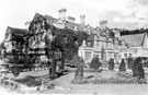 View: s20548 East front of Derwent Hall. Ornamental garden includes clipped Irish yews. Private St. Henry's Roman Catholic Chapel, right. Demolished 1940's for construction of Ladybower Reservoir