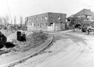 J. Childs, demolition contractors (centre) and J.W. Horton (Contractors) Ltd., sports ground contractors (right), Corby Road  from Winco Road