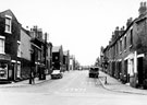 Worthing Road, Darnall, from the junction with Woodbourn Road looking towards Chelmsford Road (left), showing No. 170, R. E. Smith, butcher (right) and No. 159, corner shop, Woodbourn Road (left)