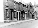 Terraced housing Nos. 55 - 61 and No. 63, Harry S. Allen Ltd., chemist in the former Brightside Methodist Church, Jenkin Road looking towards property in Court No. 3