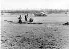 Repairing the turf at Beighton Sports Ground, High Street. Beighton junction in background