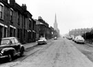 Nos. 104, 102 etc., Lyons Street, Burngreave looking towards the junction with Earsham Street, All Saints Church and terraced housing on Petre Street (right)