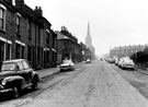 View: s21251 Nos. 104, 102 etc., Lyons Street, Burngreave looking towards the junction with Earsham Street,All Saints Church and terraced housing on Petre Street (right)
