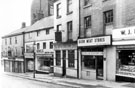 Dixon Lane showing (l. to r.) No. 26 Norfolk Arms, No. 24 T. Bates (Wallpapers) Ltd., paint merchants, No. 22 and 16a, William John King Ltd., provision dealers, No. 20 Rock Tavern, No. 18 Dixon Meat Stores