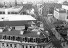 Elevated view of rooftops of property on Pinstone Street; Barkers Pool and Division Street showing the roof of the Odeon Cinema; Cole Brothers; City Hall; Barkers Pool Gardens and War Memorial